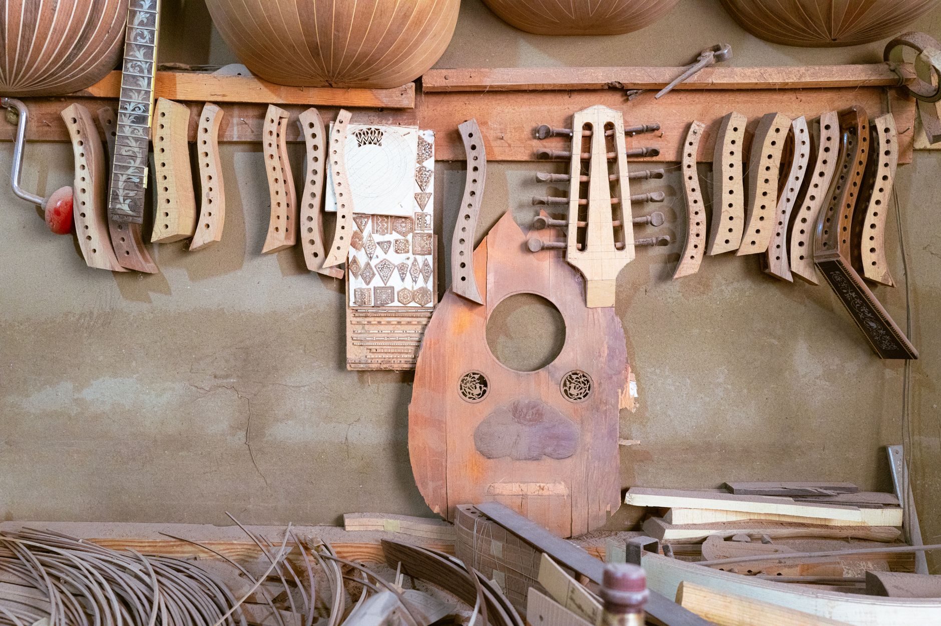 Handcrafted musical instrument parts and tools in a luthier's workshop.