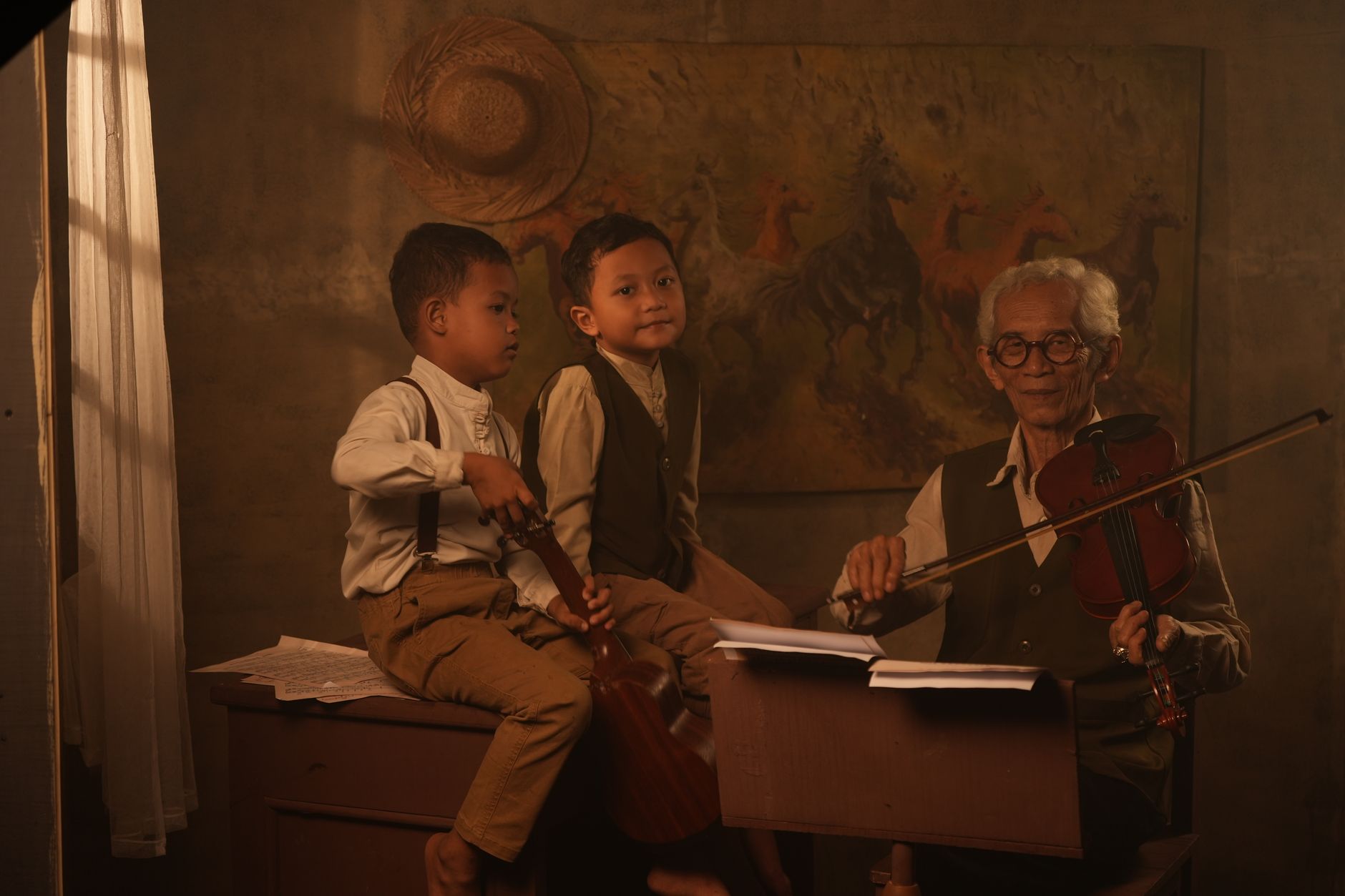 A cozy indoor scene featuring an elderly violinist teaching two young boys with guitars in Jakarta, Indonesia.