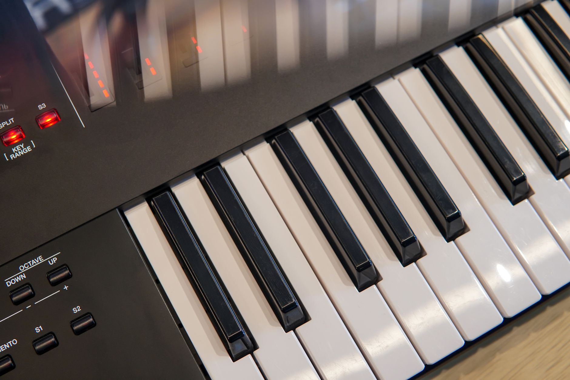 Detailed view of an electronic keyboard showcasing keys and control panel in a studio setting.