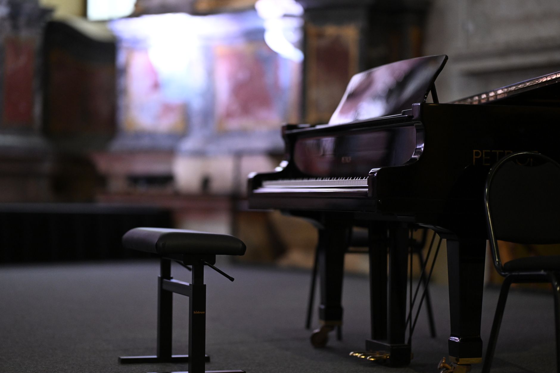 A beautiful grand piano in an ornate Vilnius concert hall setting, showcasing classic elegance.