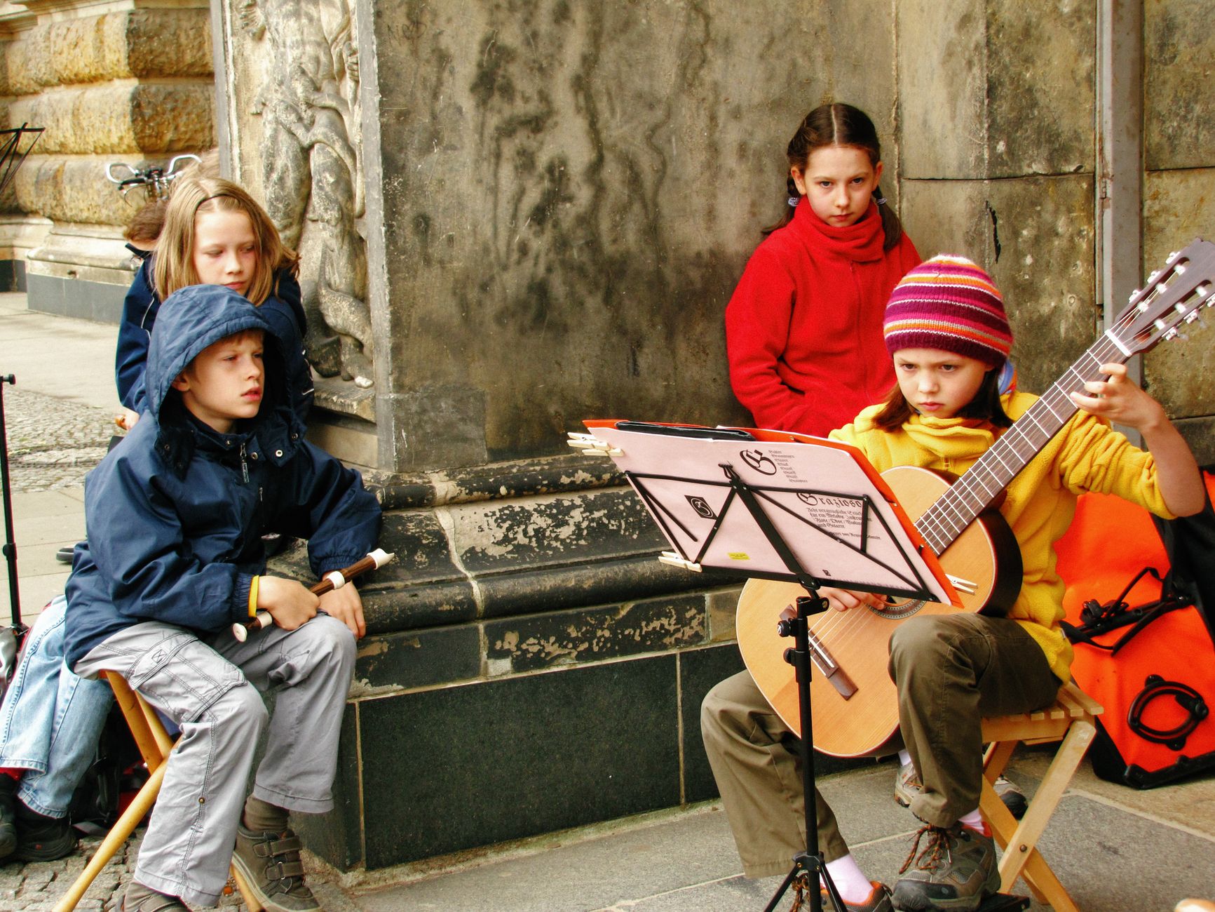 Children musicians performing on the streets of Dresden, Germany, showcasing youthful talent in a historic setting.