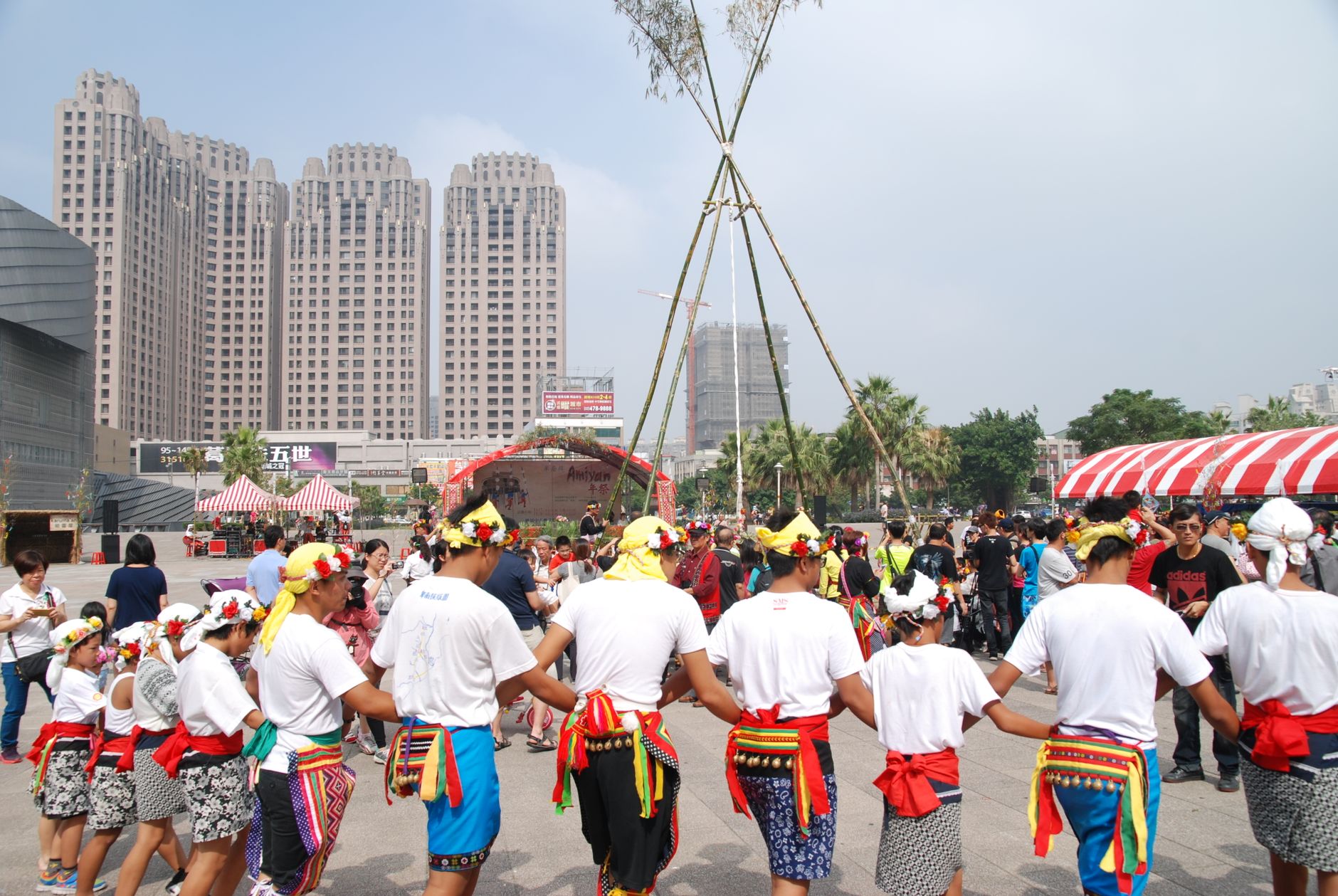 Colorful outdoor cultural festival with traditional dance performances and lively crowd.